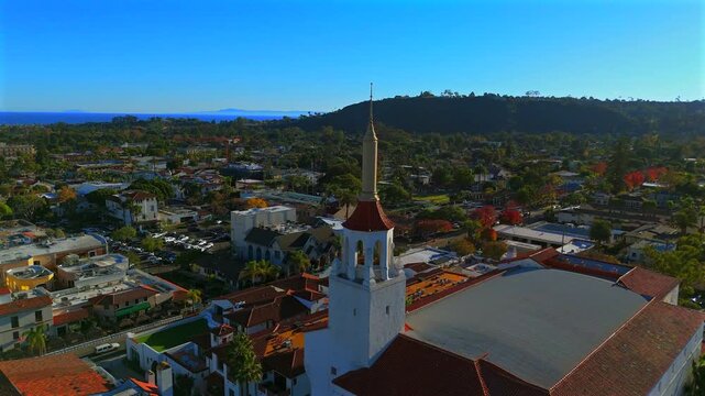 Drone close up of historic Spanish colonial tower, Santa Barbara cityscape and Pacific Ocean view