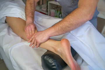 Close-up of skilled hands massaging a person's calf and ankle, promoting relaxation and muscle relief