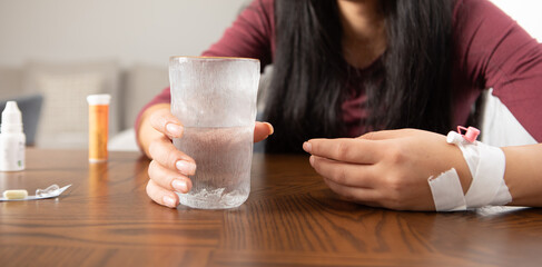 sick woman drinks water