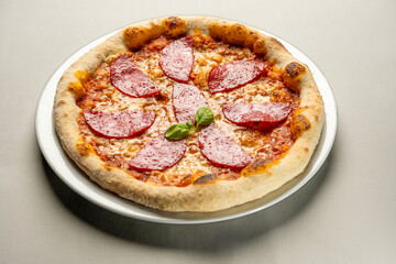 salami pizza on a white plate