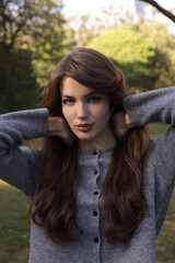  beautiful young slavic woman with long dark natural hair in elegant clothes