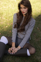  beautiful young slavic woman with long dark natural hair in elegant clothes