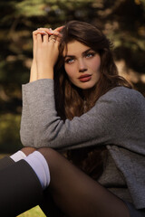  beautiful young slavic woman with long dark natural hair in elegant clothes