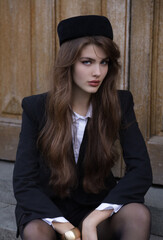  beautiful young slavic woman with long dark natural hair in elegant clothes