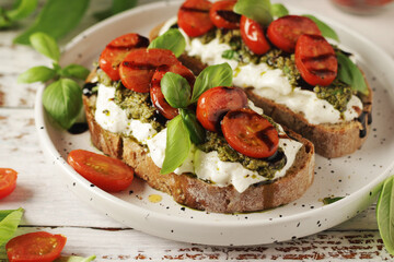 Italian sandwiches with grilled tomatoes, burrata cheese and pesto	