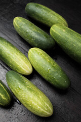 Pattern of fresh cucumbers on a wooden table