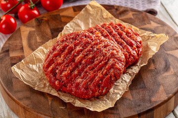Raw uncoocked red beef round cutlet