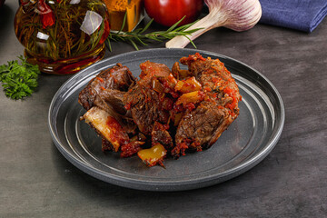 Baked beef ribs with vegetables