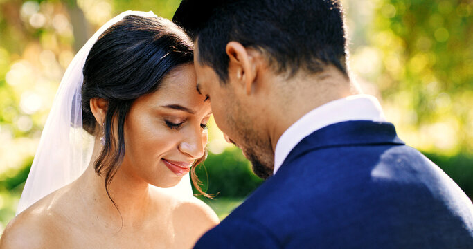 Wedding, happy couple and love in park with nature, support and celebration for bridal union or marriage. Bride, groom and forehead touch in garden for life partner, commitment and together outdoor