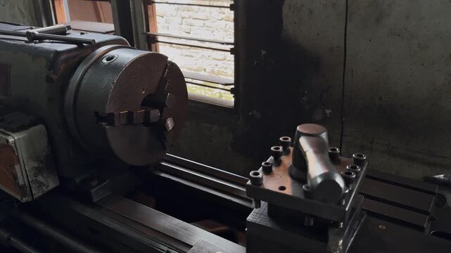 Industrial metalworking lathe machine showing the chuck and tool post