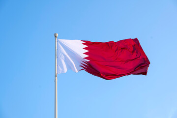 Doha, Qatar- December 10, 2025: Qatar Flag flying high in the wind. National Museum Qatar 