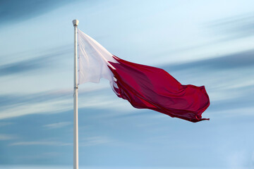 Doha, Qatar- December 10, 2025: Qatar Flag flying high in the wind. National Museum Qatar 