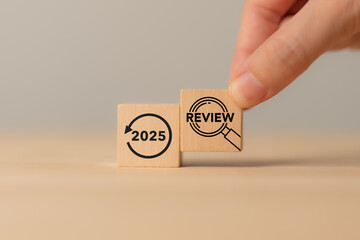 2025 business review, wooden blocks with 2025 and review icon. Business and customer review for...