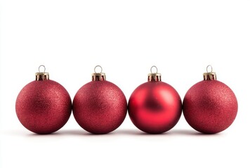 A row of four red Christmas ornaments isolated on a white background.