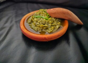 hand holding guacamole Sambal hijau,Sambal Ijo,Sambal lado mudo,Green chili sambal,Green chili paste,Green chili sauce.Traditional Indonesian sambal from West Sumatra