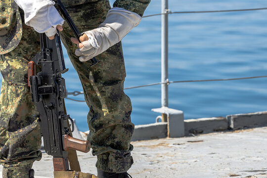 A soldier loads an automatic rifle to protect a ship from terrorists.
- Powered by Adobe