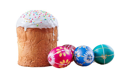 A festive composition featuring a tall Easter cake with white dripping glaze and colorful sprinkles, accompanied by three brightly painted eggs (pink, blue, and teal) with floral and geometric pattern