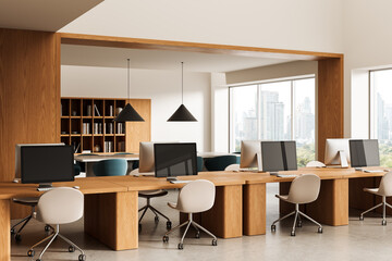 Modern open office with wooden desks, stylish chairs, and desktop computers in a bright workspace with large windows and cityscape background. 3D Rendering