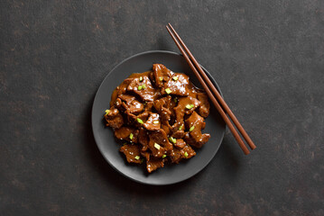 Asian style beef with soy sauce, green onion and sesame seeds