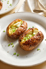 Baked filled potatoes with butter and green onion