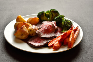 Sunday Roast with roasted beef, carrots, crispy potato and broccoli