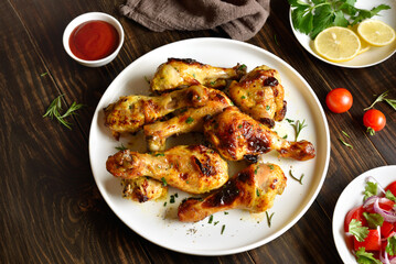 Barbecue roasted chicken drumsticks served with sauce