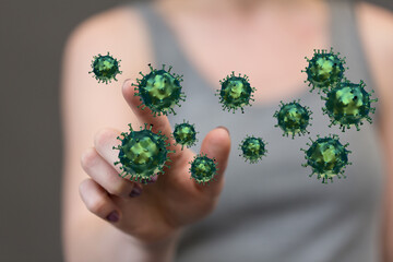 Abstract visual of a female hand interacting with floating coronavirus models. A concept of disease and virus