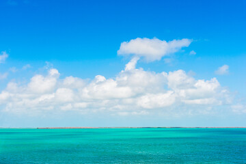Blue sky with white clouds over the turquoise sea in Florida Keys