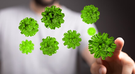 Close up of a hand touching 3D rendered green virus cells concept about the spread of infection and disease.
