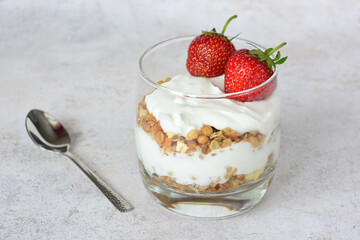 Healthy Yogurt Parfait with muesli and Fresh Strawberries in a glass