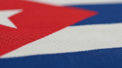 Macro shot of the national flag of cuba featuring red, white, and blue colors.