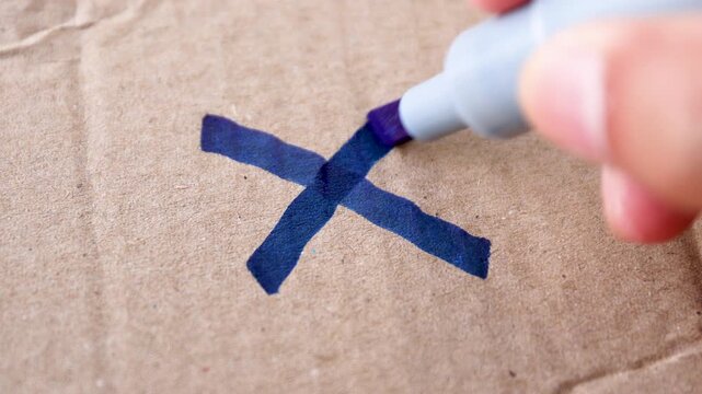 cross mark, reject, no, error, wrong, a hand drawing a cross x mark with a blue marker on brown paper, symbolizing rejection, mistake, or disagreement, close-up