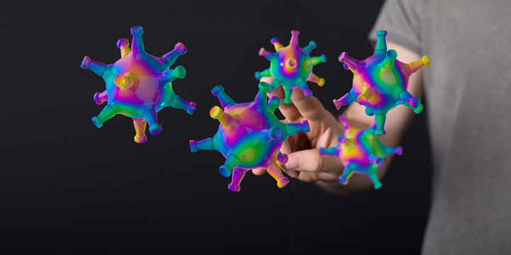 Abstract and colorful conceptual image of coronavirus cells in the air, near a person's hand, representing con - Powered by Adobe
