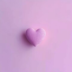 Obraz premium Pink heart-shaped object on a matching purple background, symbolizing love and affection.