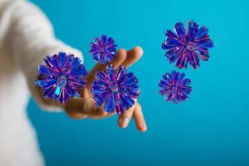 Abstract conceptual image featuring digital representation of a virus floating over a hand. Symbolic represent