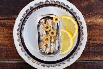 Can of canned oil sardines on a elegant plate