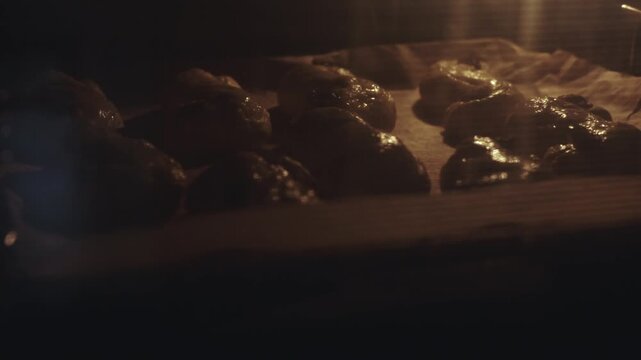 s-shaped yellow pastries, traditional Scandinavian holiday bakery with resins and chocolate raw dough ready for baking, being put in the oven. desaturated footage easily color matched