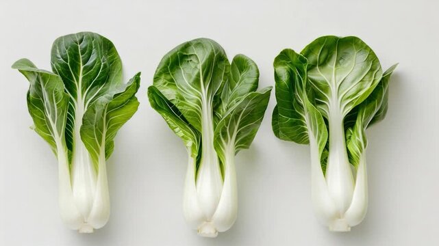 Video A close-up shot of three crisp pieces of lettuce sitting on a clean white surface