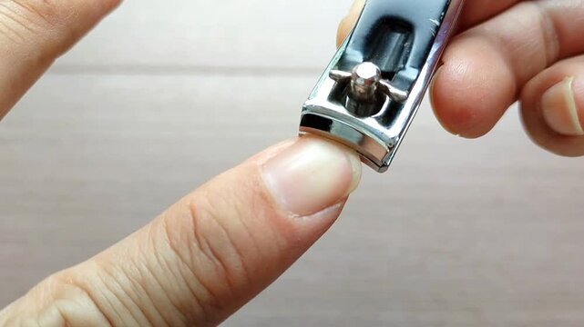 Health concept. Close-up image of cutting the nails of the little finger and ring finger. Nail cutting concept. Unhealthy lifestyle: long and dirty nails. Concept of maintaining body hygiene. Soft foc