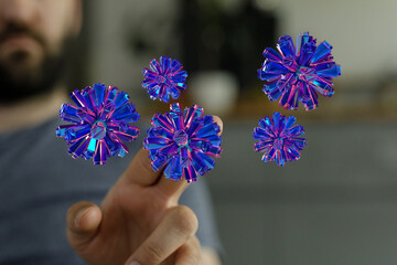 Artistic rendering of a person interacting with digital, futuristic flowers. Highlighting...