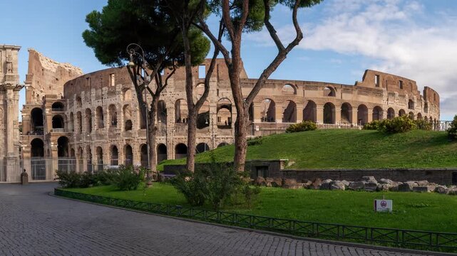 Panoramic view of the iconic Colosseum and the Arch of Constantine in Rome, Italy, on a bright day. Ancient Roman architecture and historical landmark.