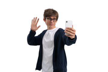 Casual man in glasses wearing white t-shirt and hoodie waving while taking a selfie with smartphone, isolated on white background, concept of communication