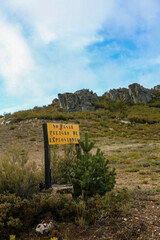 Translation: Avoid danger of explosions. Yellow background sign in a mountainous mining or military area warning of the danger of explosions