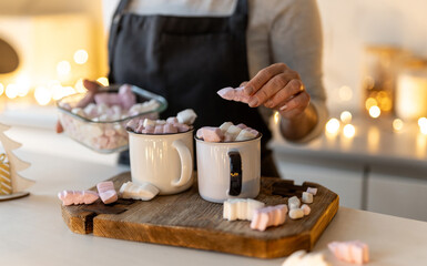Woman Preparing Hot Cocoa Drink In Christmas Decorated Kitchen