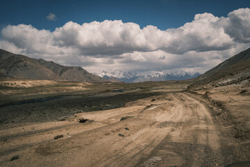 Spectacular landscape of the remote Bartang Valley in Tajikistan. Rugged mountain peaks rising above the glacial river in the heart of the Pamirs (GBAO region).