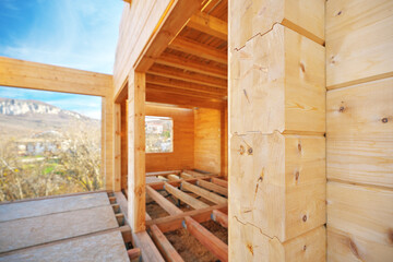 Building a wooden house on the construction site.