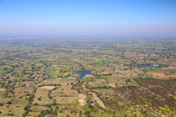 Mhaismal, MH, India, Dec 12, 2025 Panoramic aerial view of rural farmland and lakes seen from hilltop viewpoint