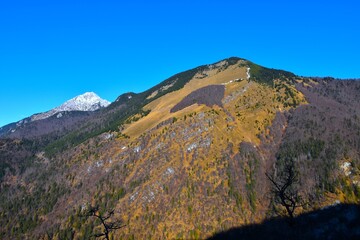 View of Srednji vrh mountain and Hudičev Boršt forest and the peak of Storžič in Gorenjska, Slovenia