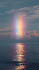 Fototapeta premium Rainbow over water at sunset
