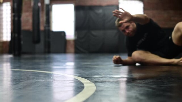 Selective focus blurred out background video of mma gym, martial arts boxing, kickboxing, training, wrestling jiujitsu, people training, jiujitsu warmup